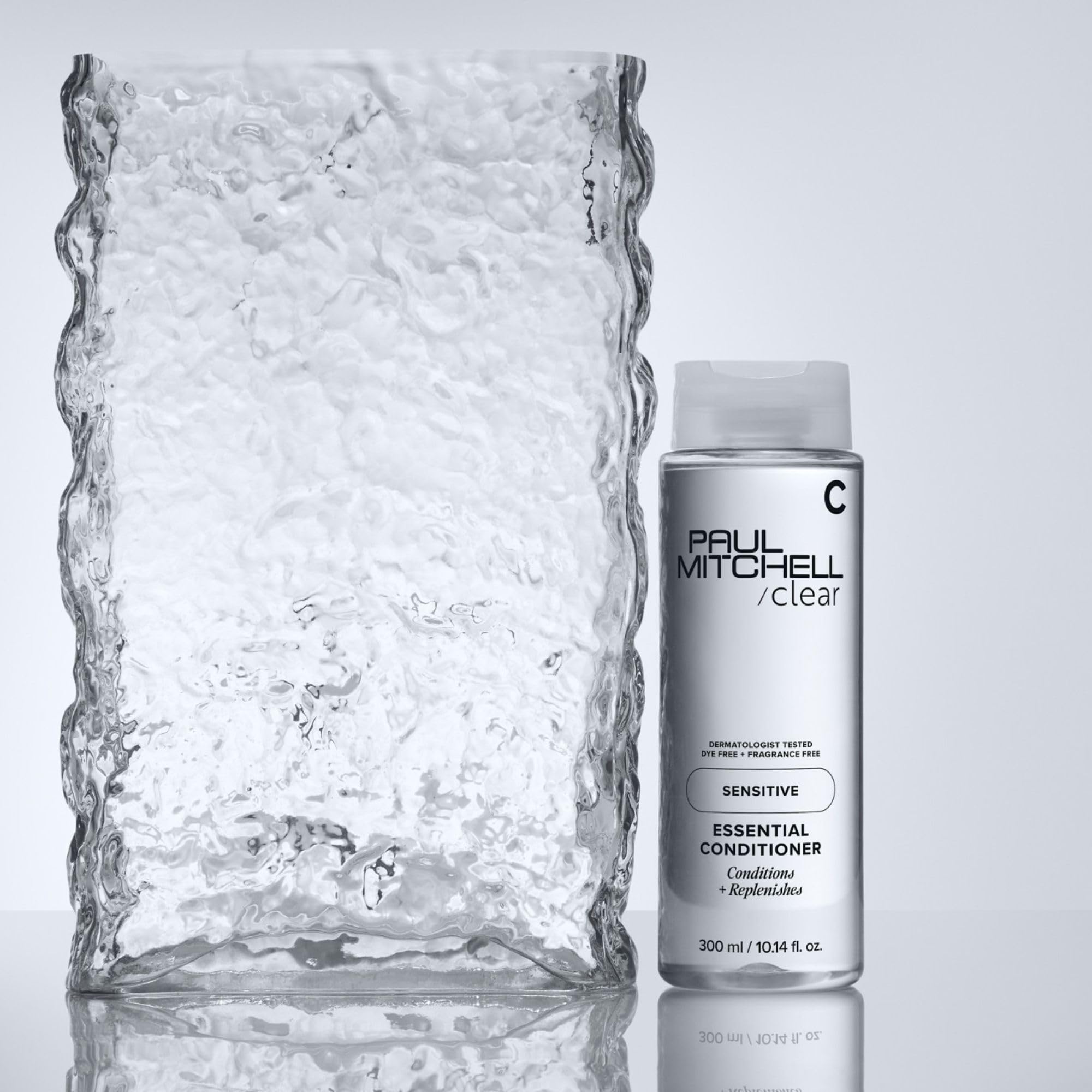 Paul Mitchell bottle next to a ruler showing the 10.14 fl oz scale