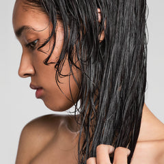 Paul Mitchell glaze on a dresser among neutral decor showing everyday styling convenience