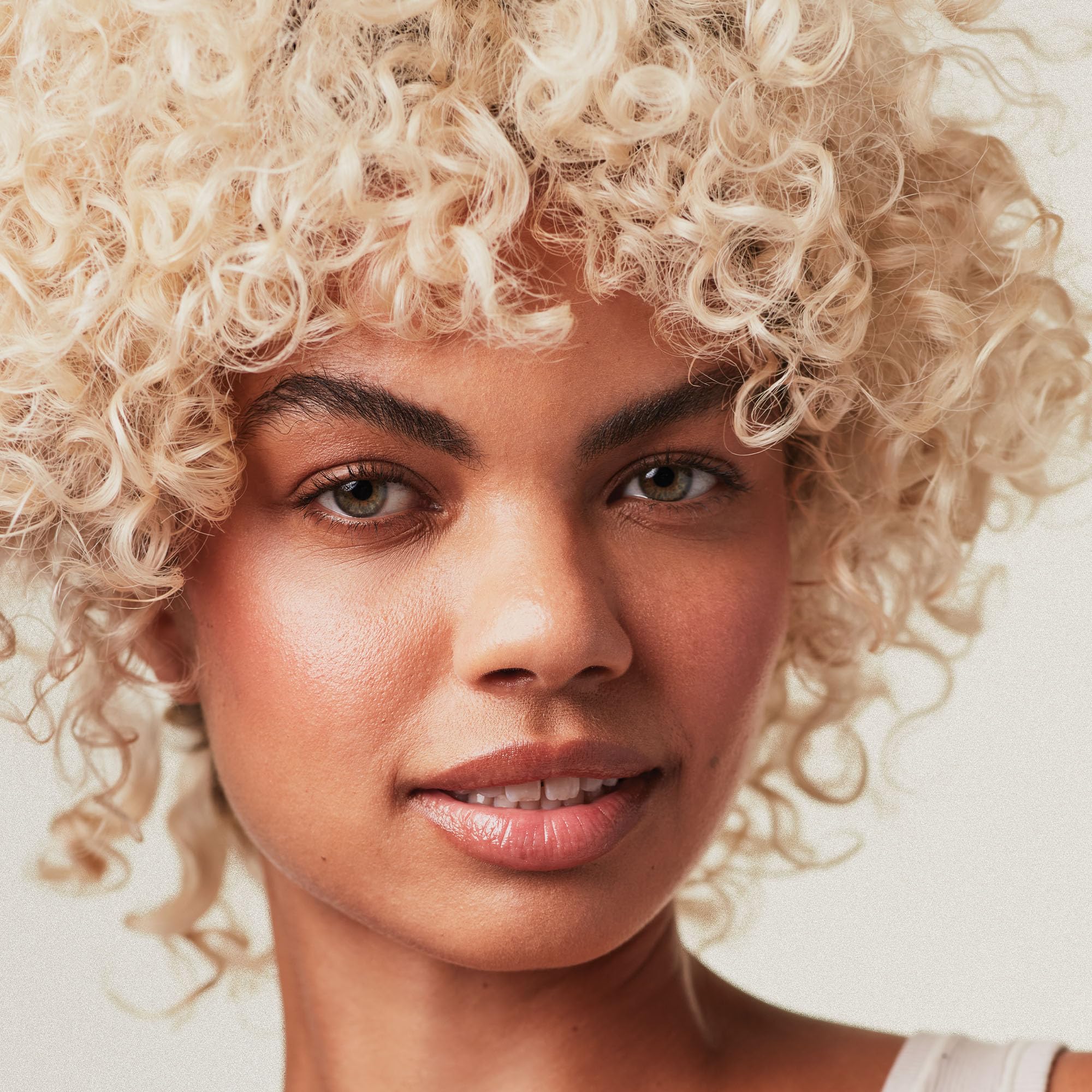 Paul Mitchell before-and-after blonde hair comparison showing reduced brass