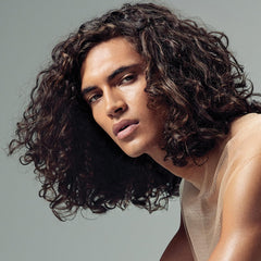 Paul Mitchell applying serum to damp curls for faster styling