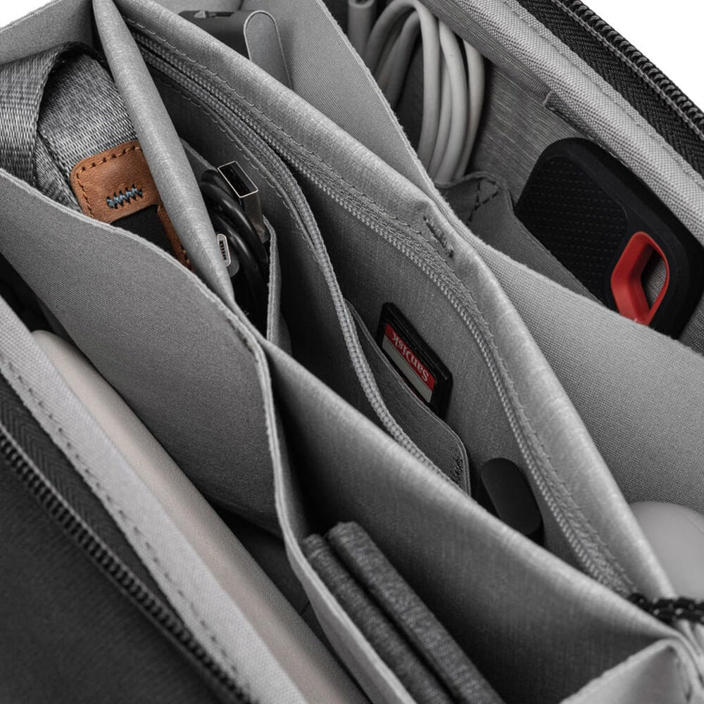 Peak Design tech pouch inside a backpack showing compact scale and travel-friendly fit