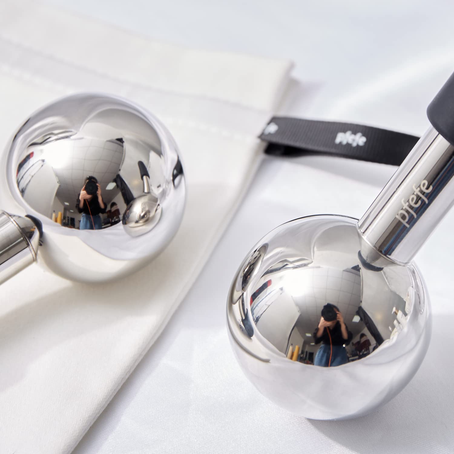pfefe globe next to hand showing compact size and travel-friendly benefit