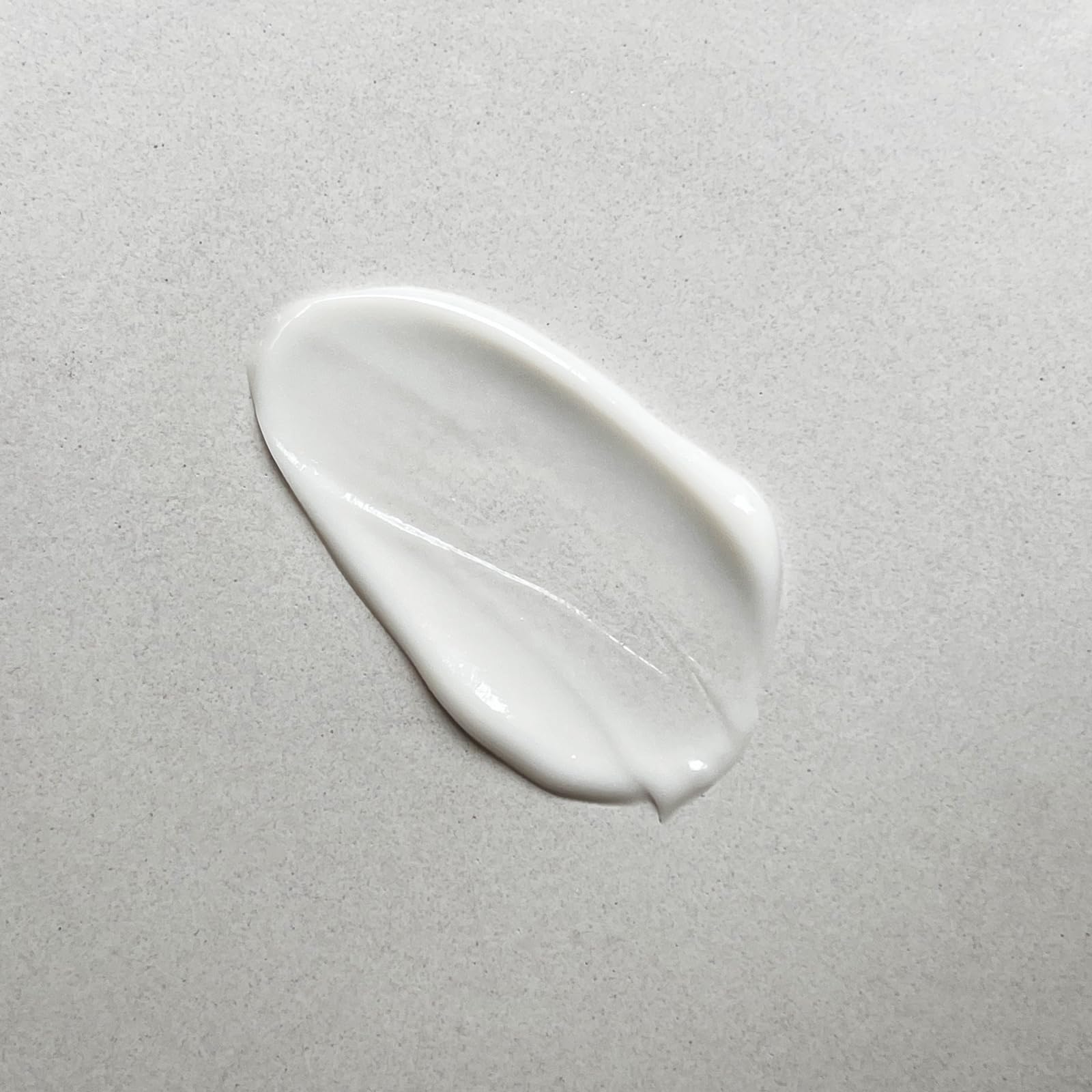 Pharmacopia close-up pump dispensing lotion revealing silky, fast-absorbing texture