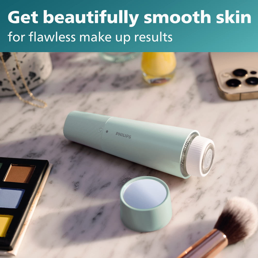 Philips Beauty accessories including cleaning brush and AA battery for maintenance