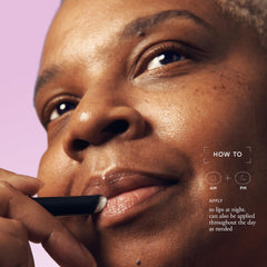 philosophy model applying stick to lips for visible smoothing and priming