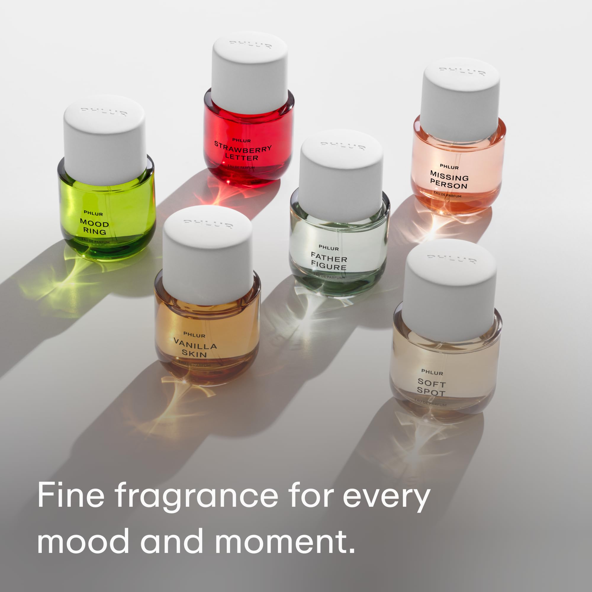 PHLUR bottle in hand demonstrating compact 50 mL scale for travel