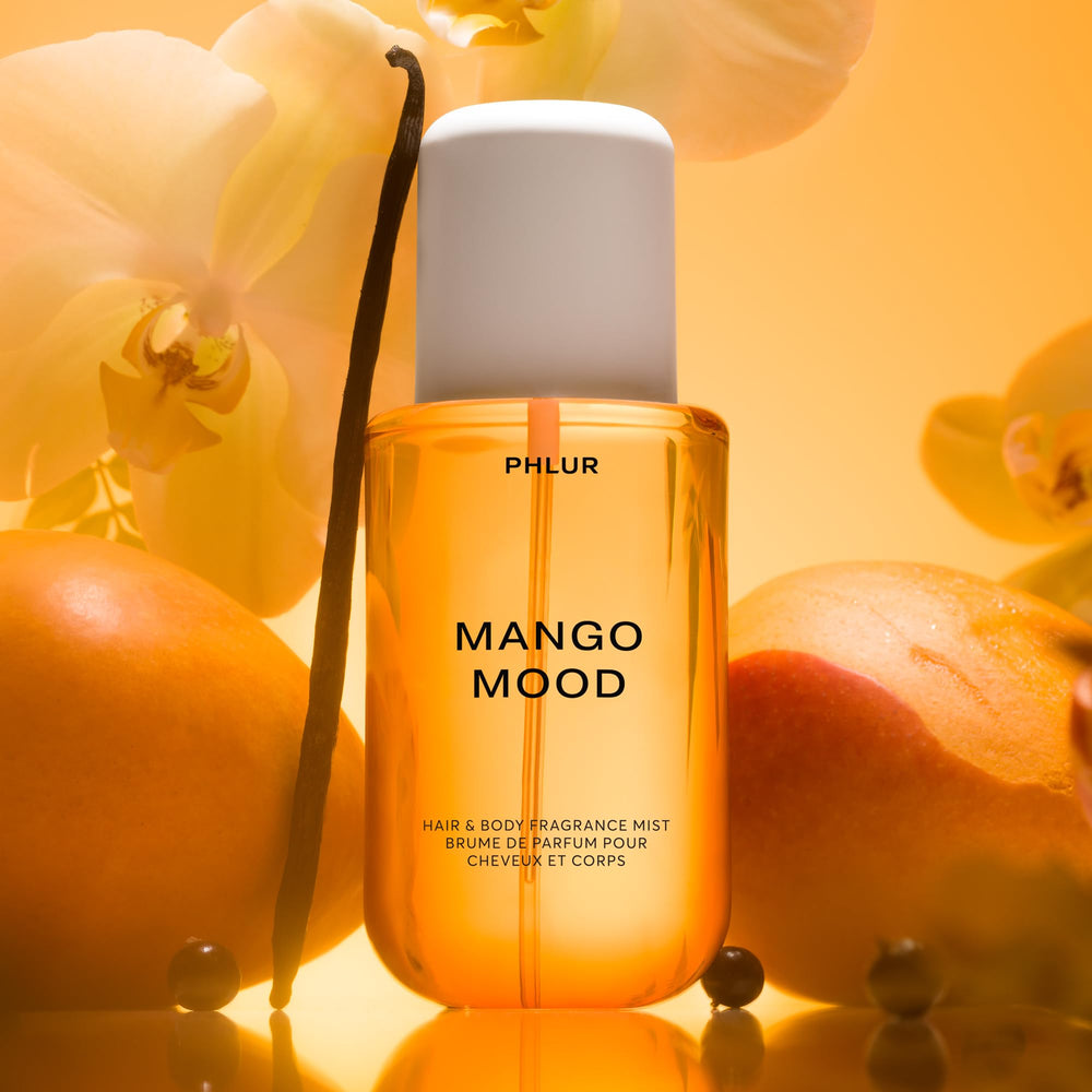 PHLUR Mango Mood being applied to hair for lasting, fresh tropical scent