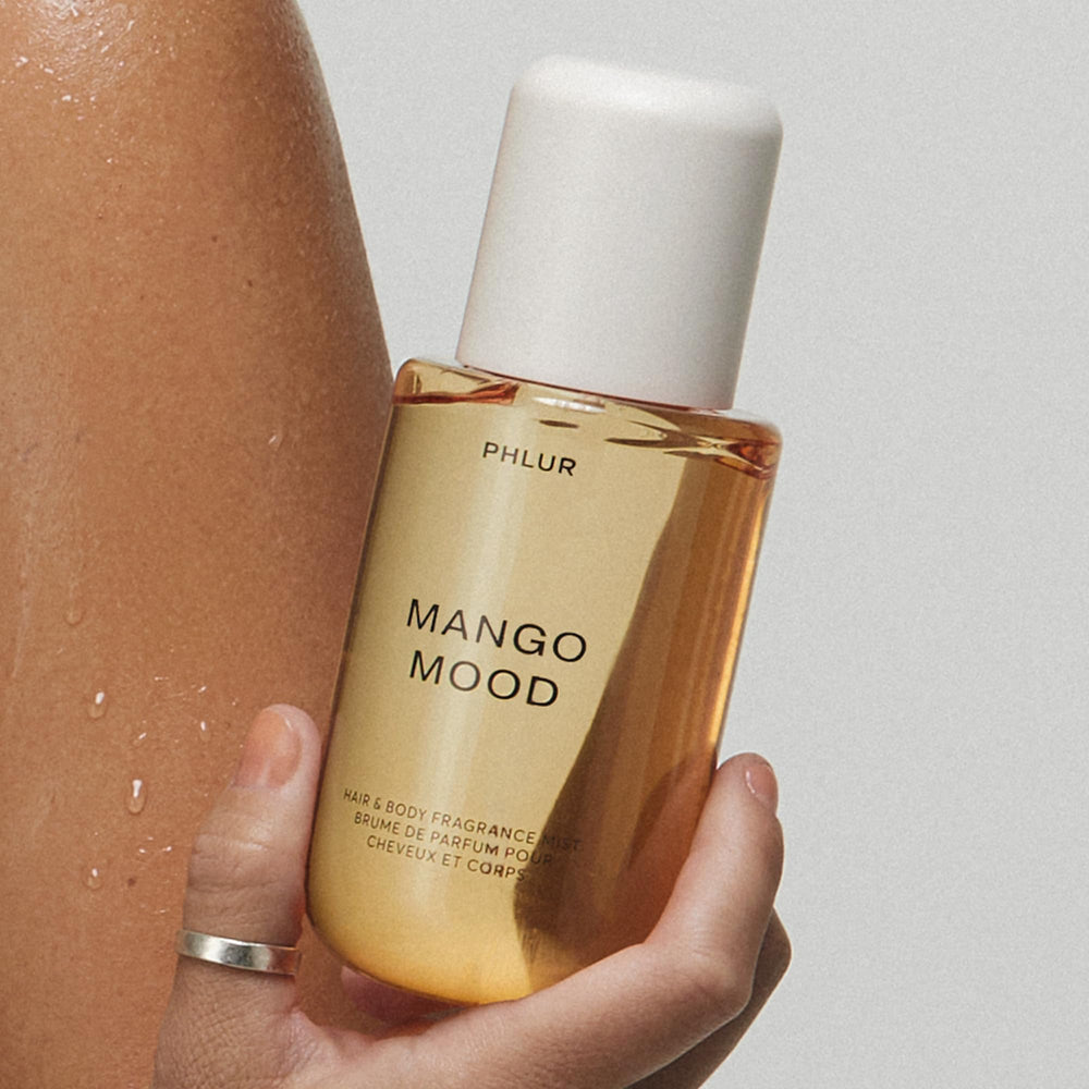 PHLUR Mango Mood held in hand to show 8 fl oz scale and portability