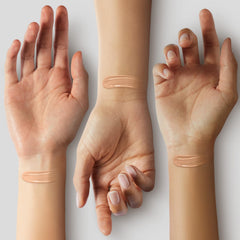Physicians Formula applying cream on hand to show sheer coverage benefit