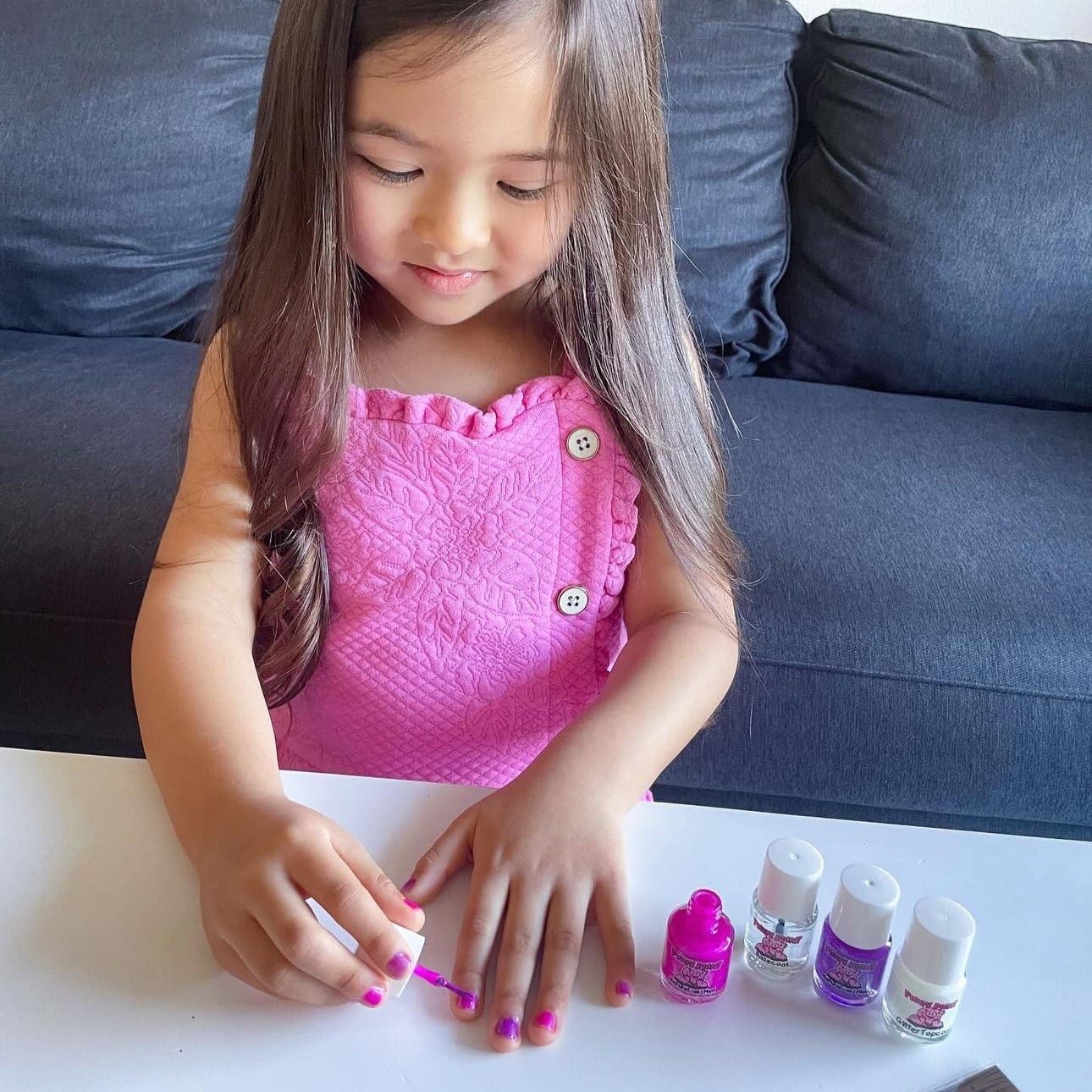 Piggy Paint polish being applied to a child’s hand demonstrating safe, low-odor benefit
