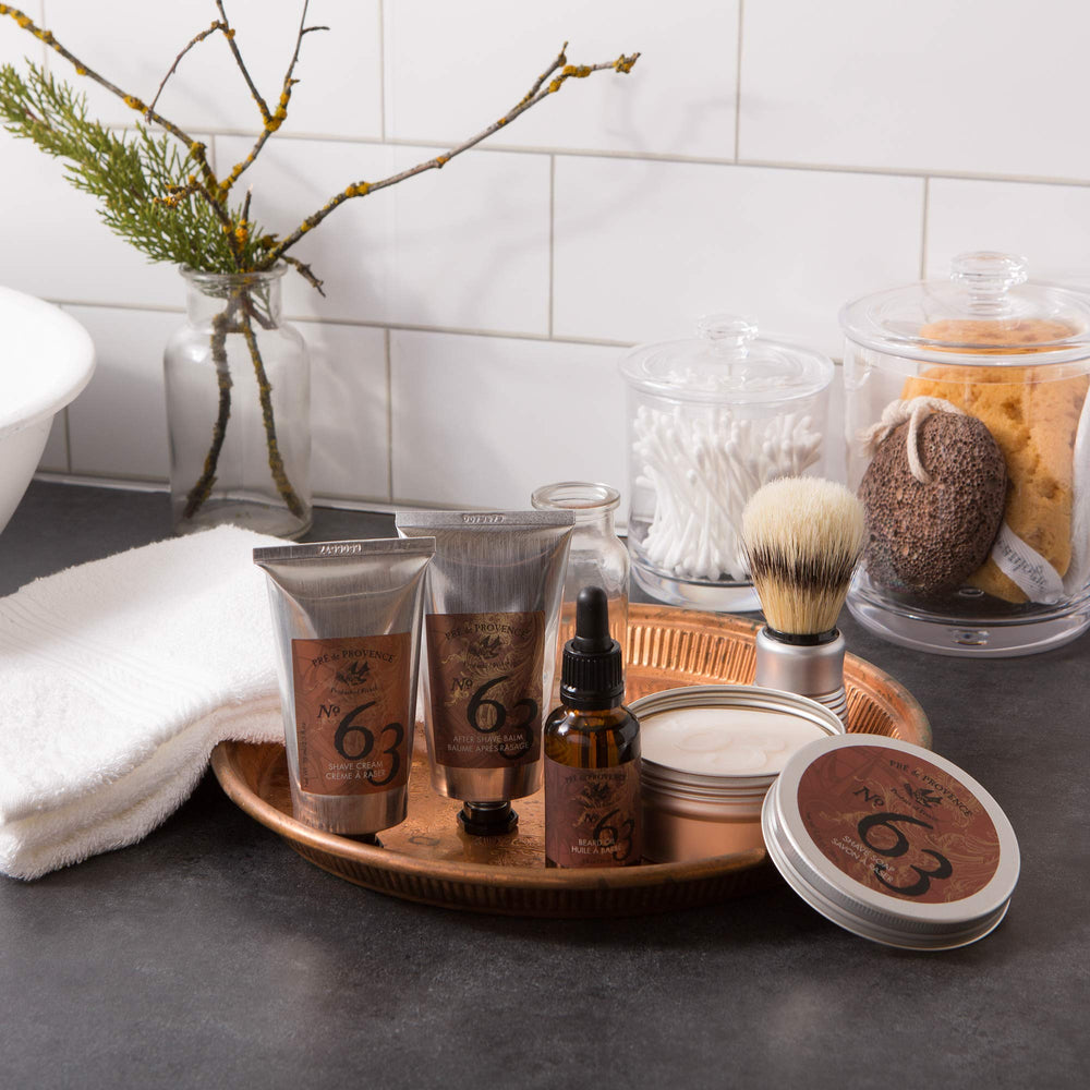 Pre de Provence balm in palm being applied to face to reduce post-shave irritation