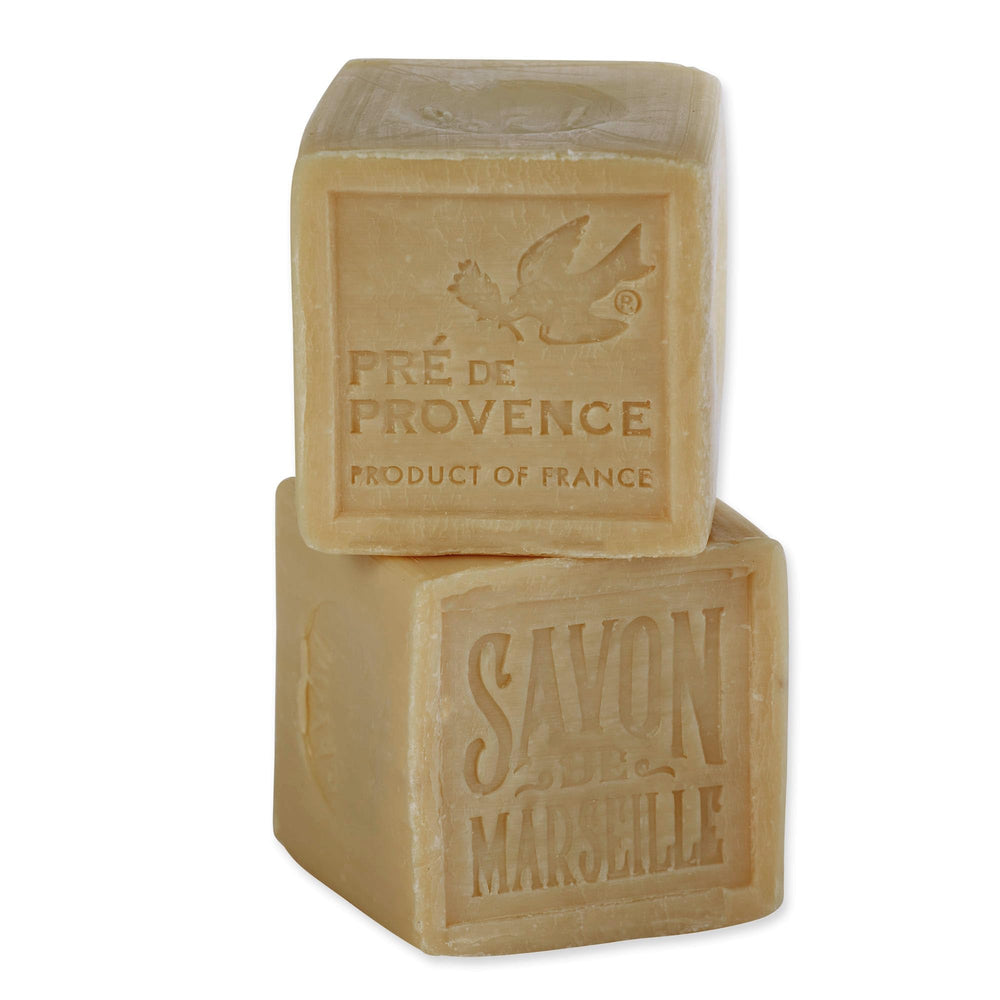 Pre de Provence soap shavings beside laundry illustrating stain-fighting flakes benefit