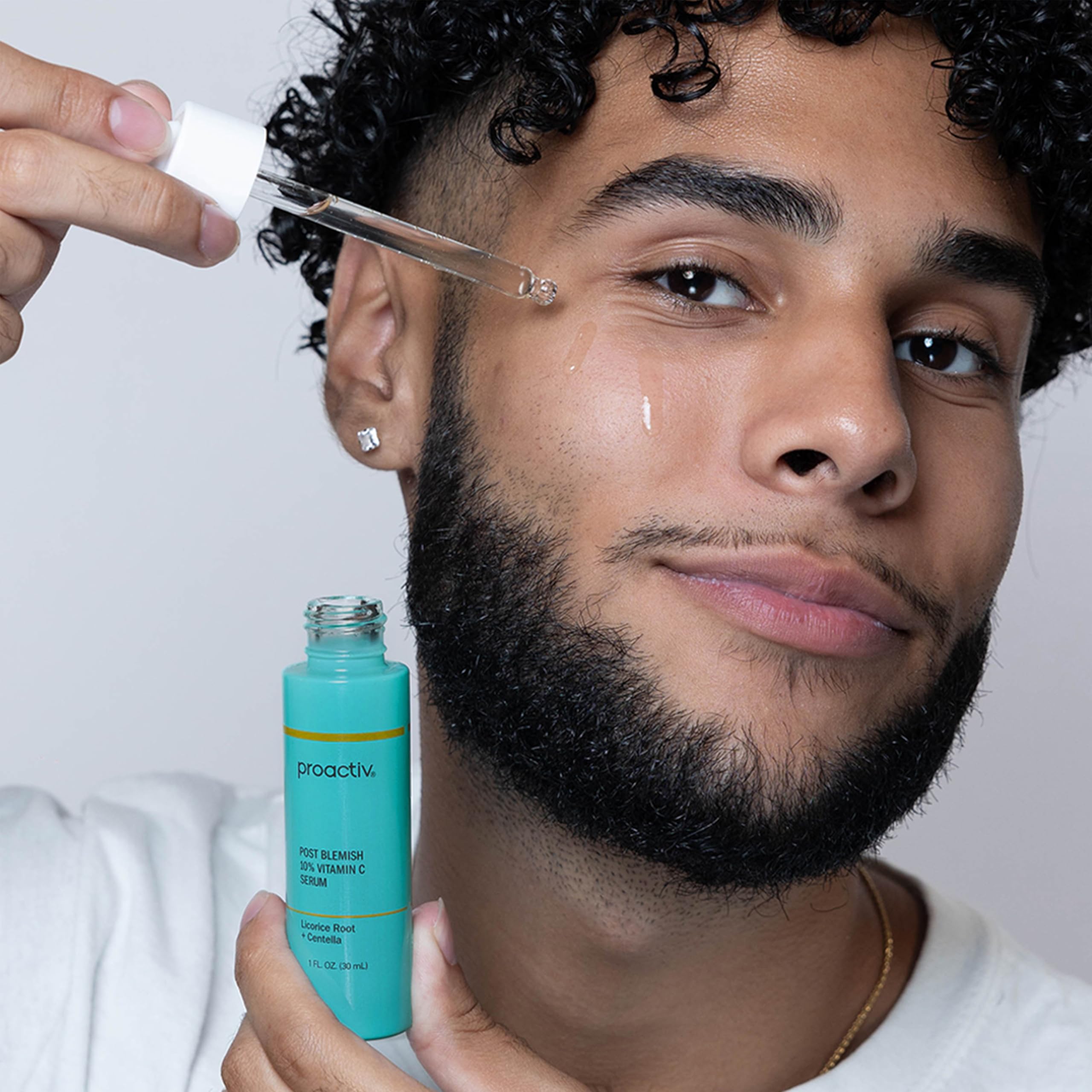 Proactiv serum next to a coin for size comparison and portability
