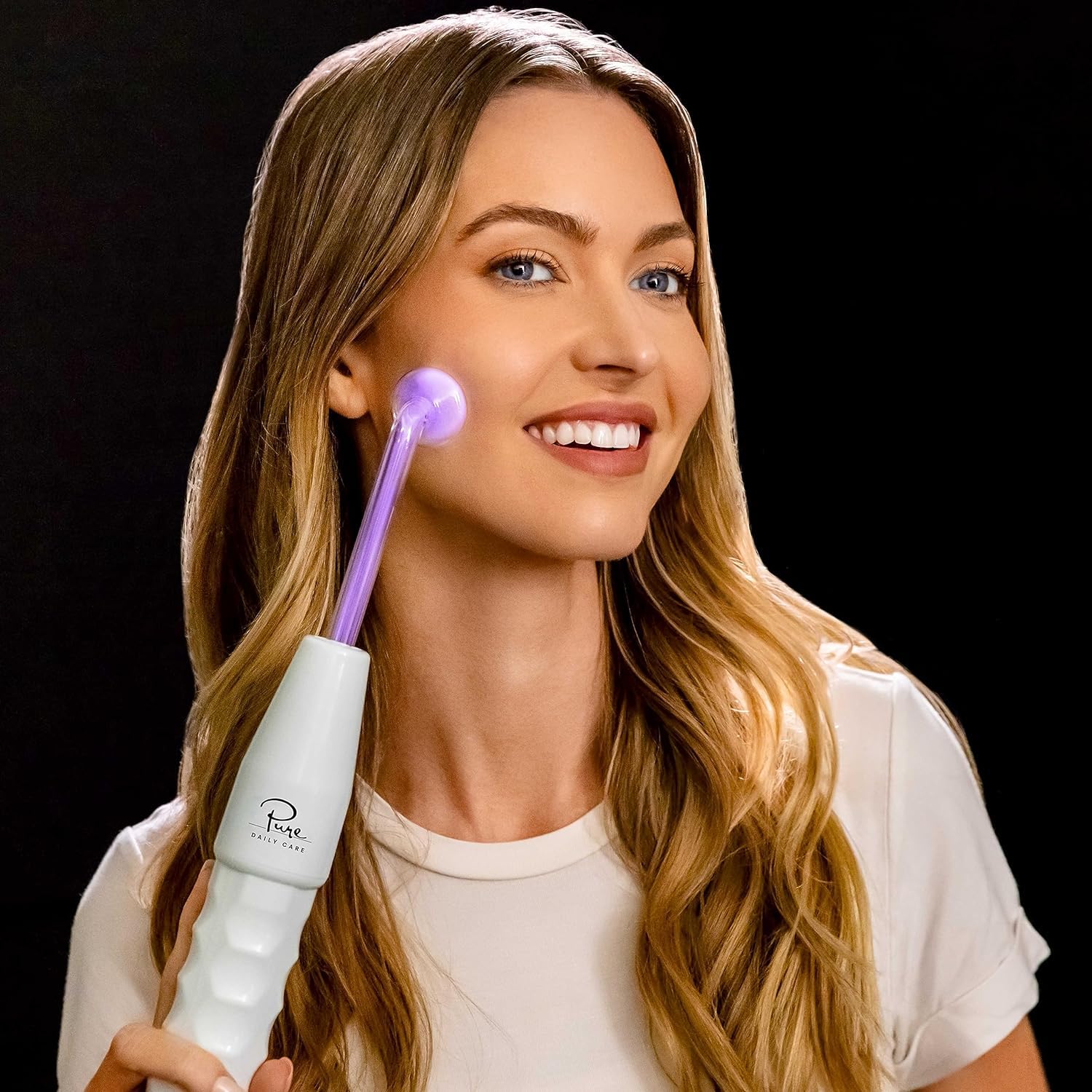 Pure Daily Care NuDerma Clinical comb wand on scalp to energize hair