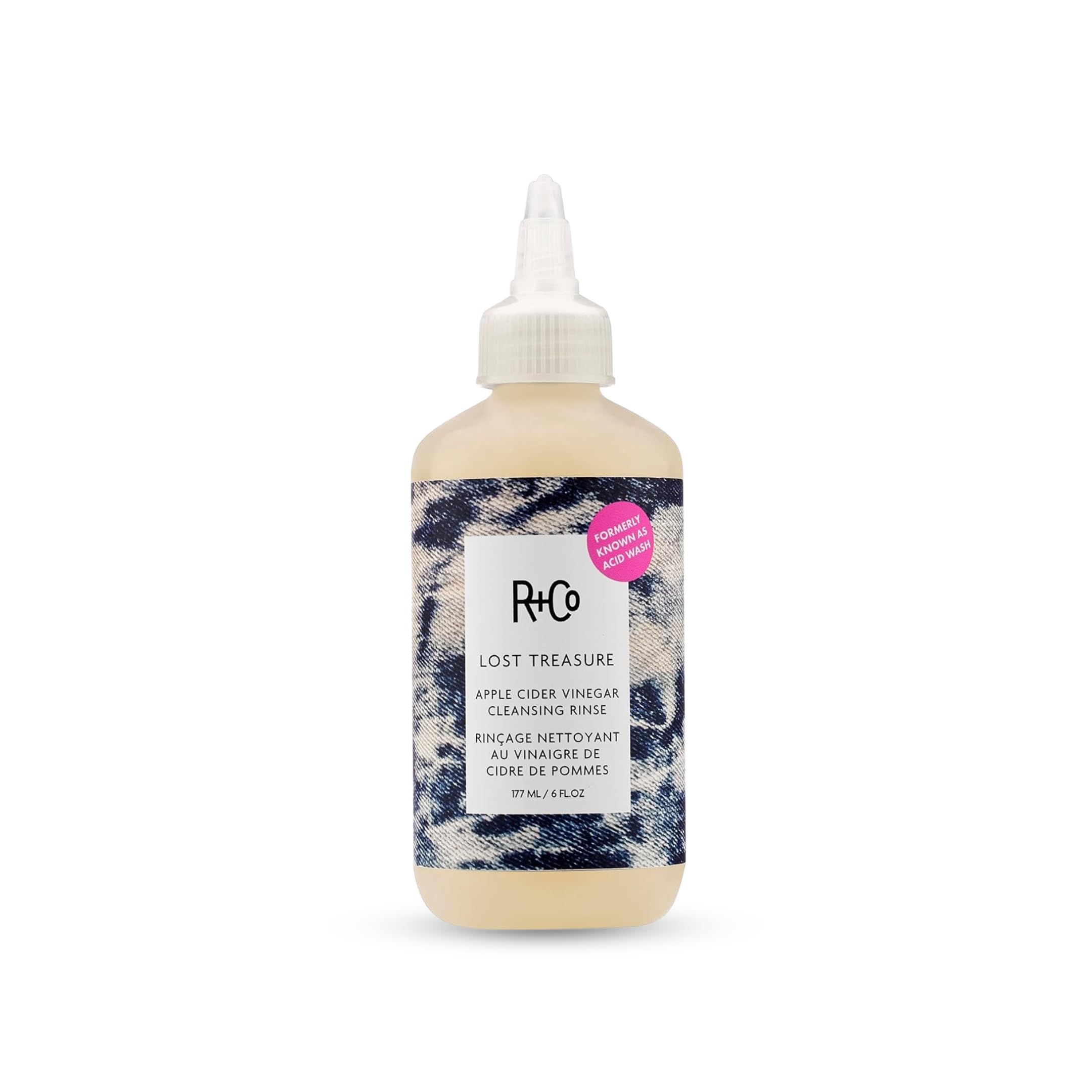 R+Co bottle front view showing label and compact 6 oz size for travel convenience