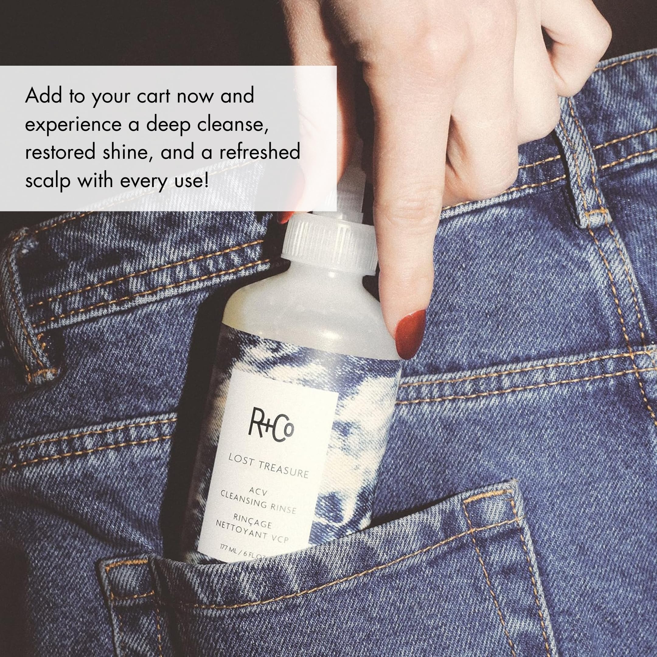 R+Co bottle on bathroom vanity styled with towels conveying polished, salon-fresh shine