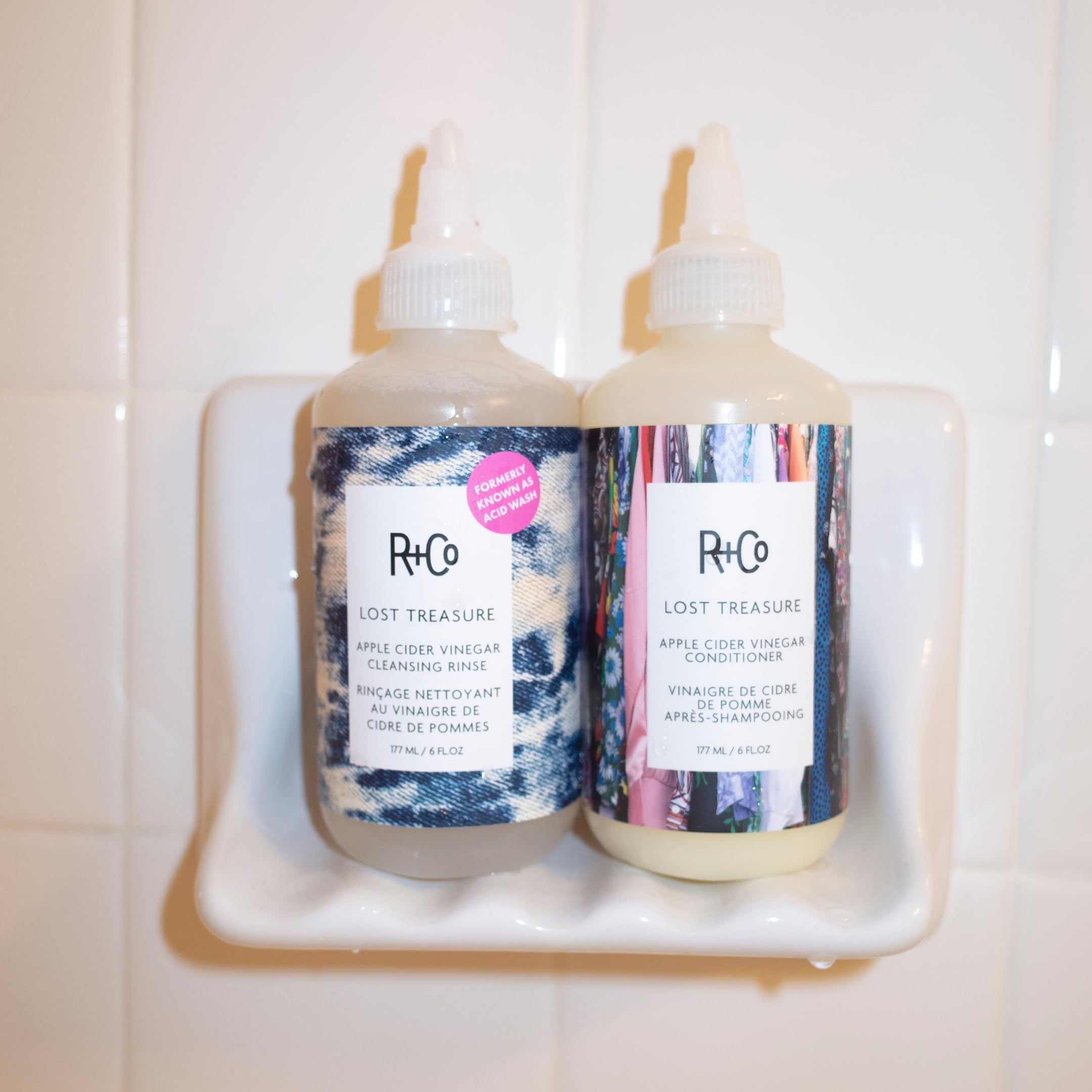 R+Co bottle next to coin illustrating the compact 6 oz travel-friendly advantage