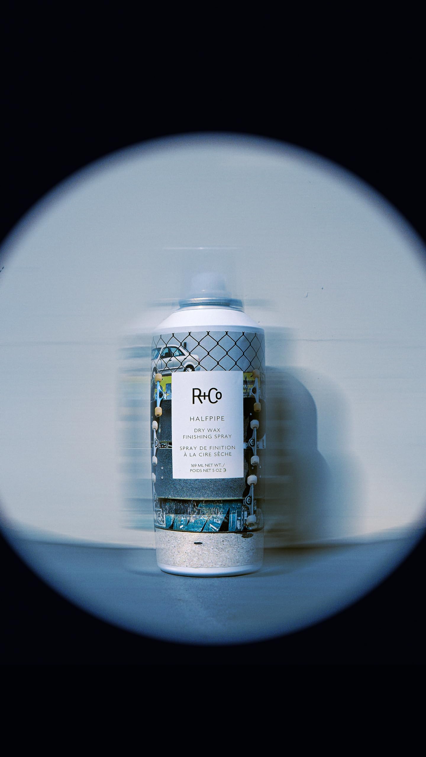 R+Co HALFPIPE next to hand for 5 oz size and travel-friendly benefit