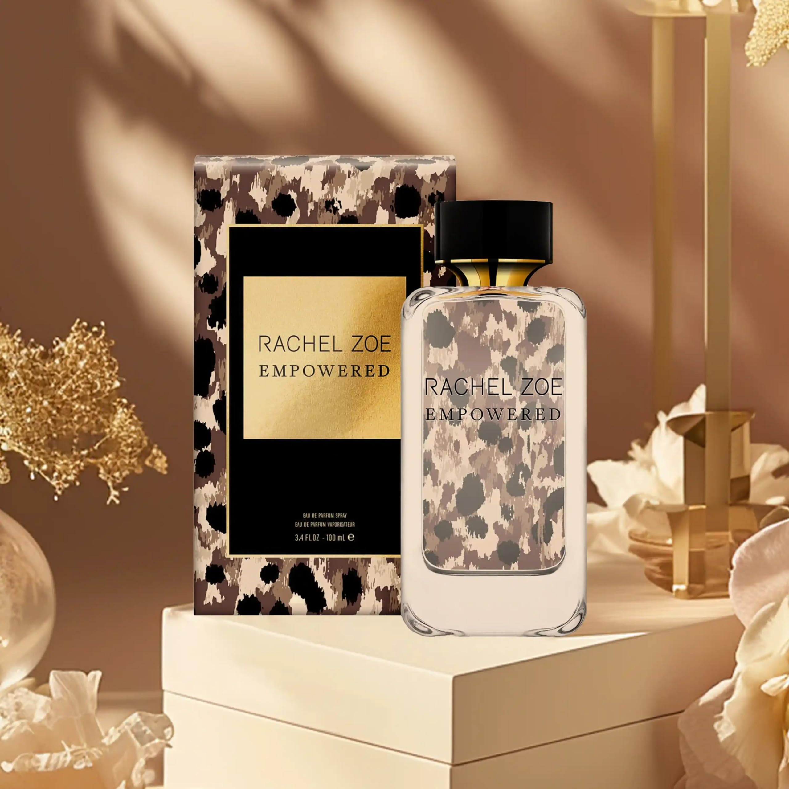Rachel Zoe 3.4 oz bottle next to everyday items illustrating portable size