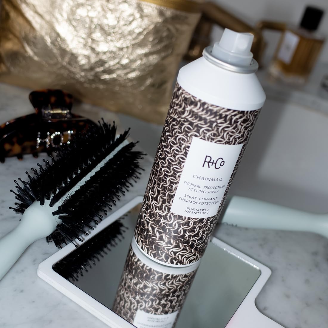 R+Co CHAINMAIL used during hot-tool styling on hair, creates smooth shiny finish benefit