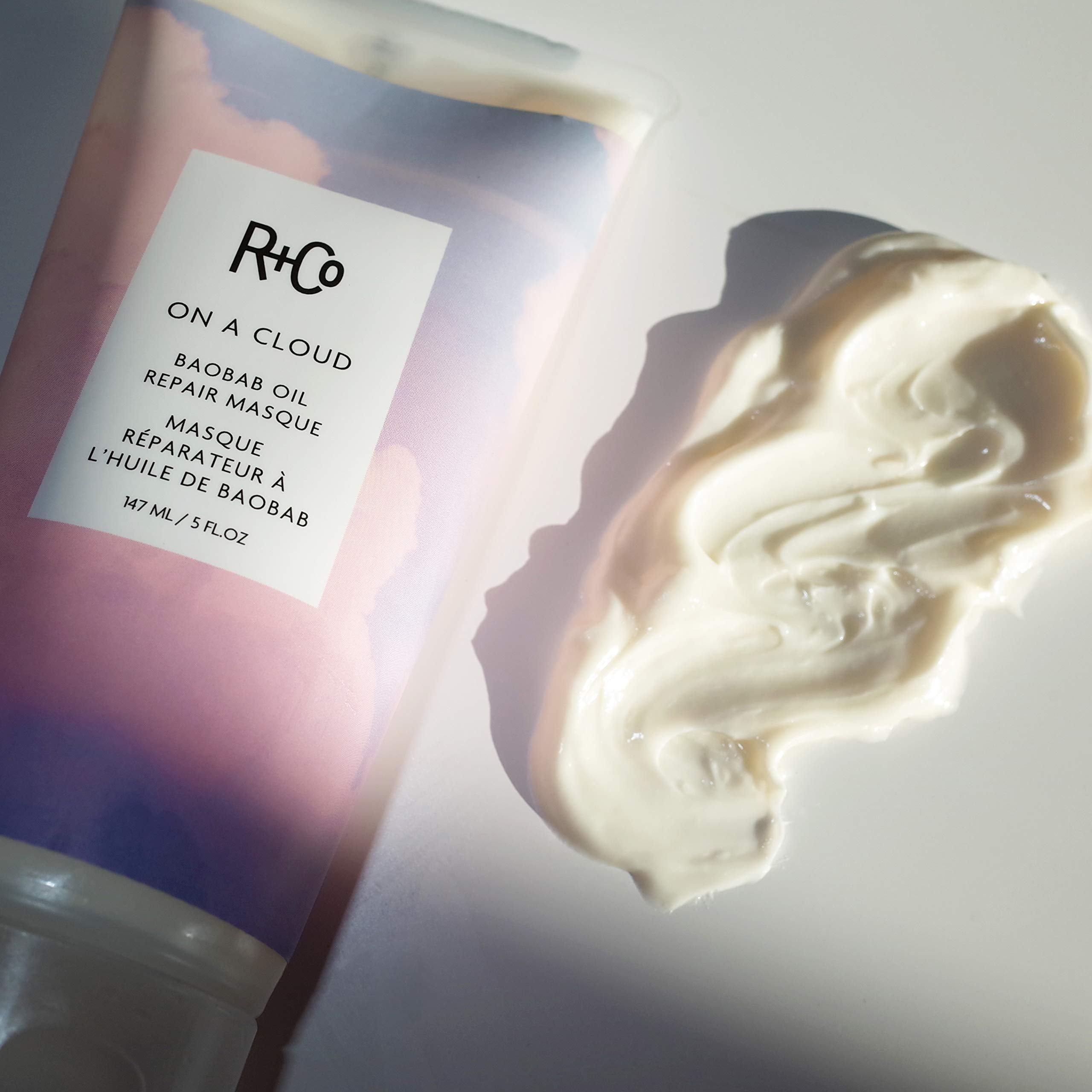 R+Co being applied to wet hair for smoothing and repair benefits