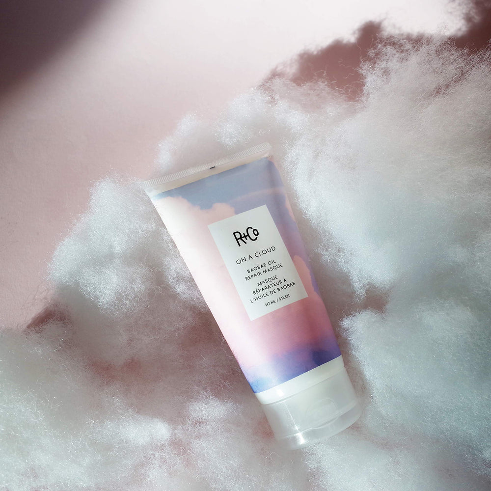 R+Co jar held in hand to show scale and travel-friendly benefit