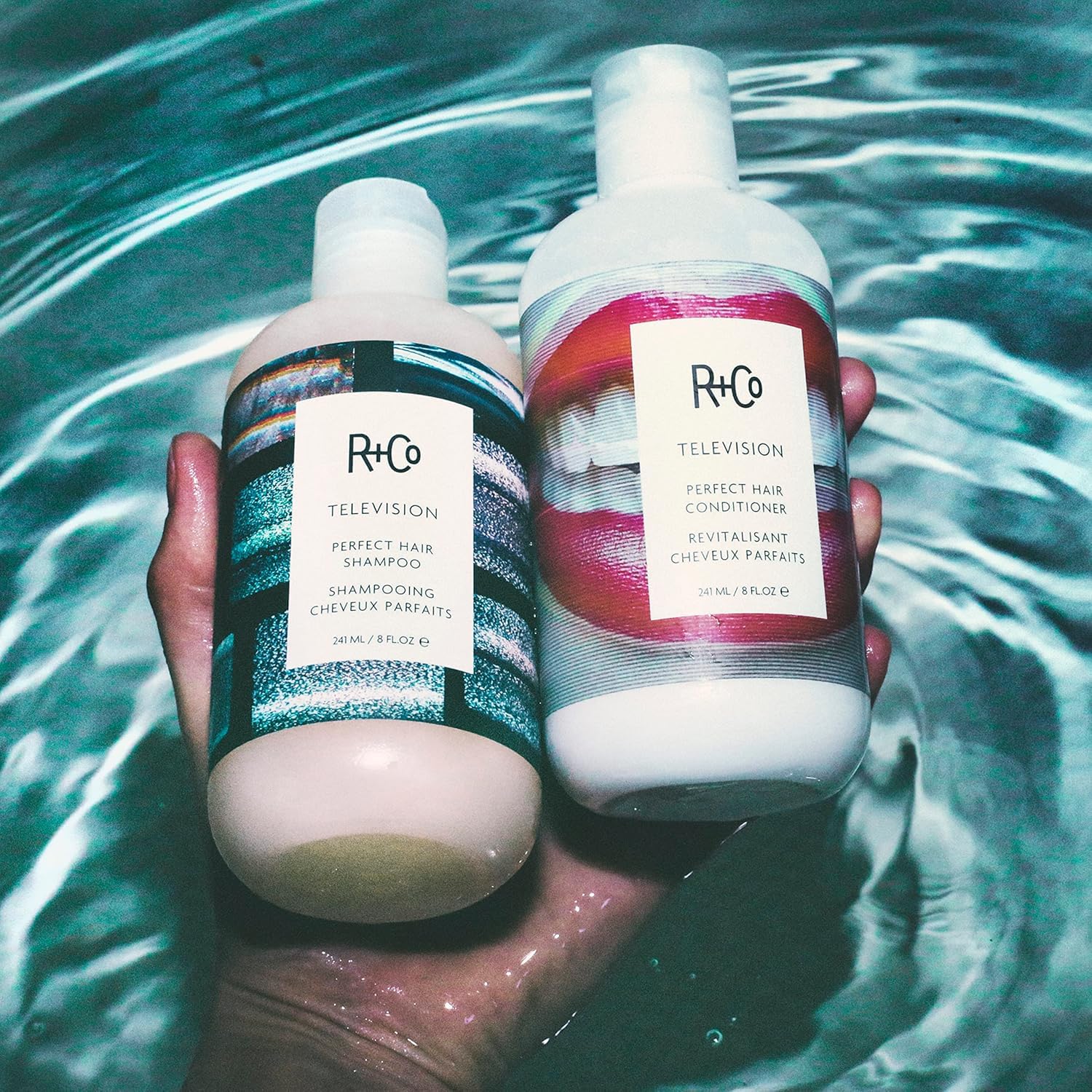 R+Co Television conditioner cream texture on fingertip illustrating smooth detangling benefit