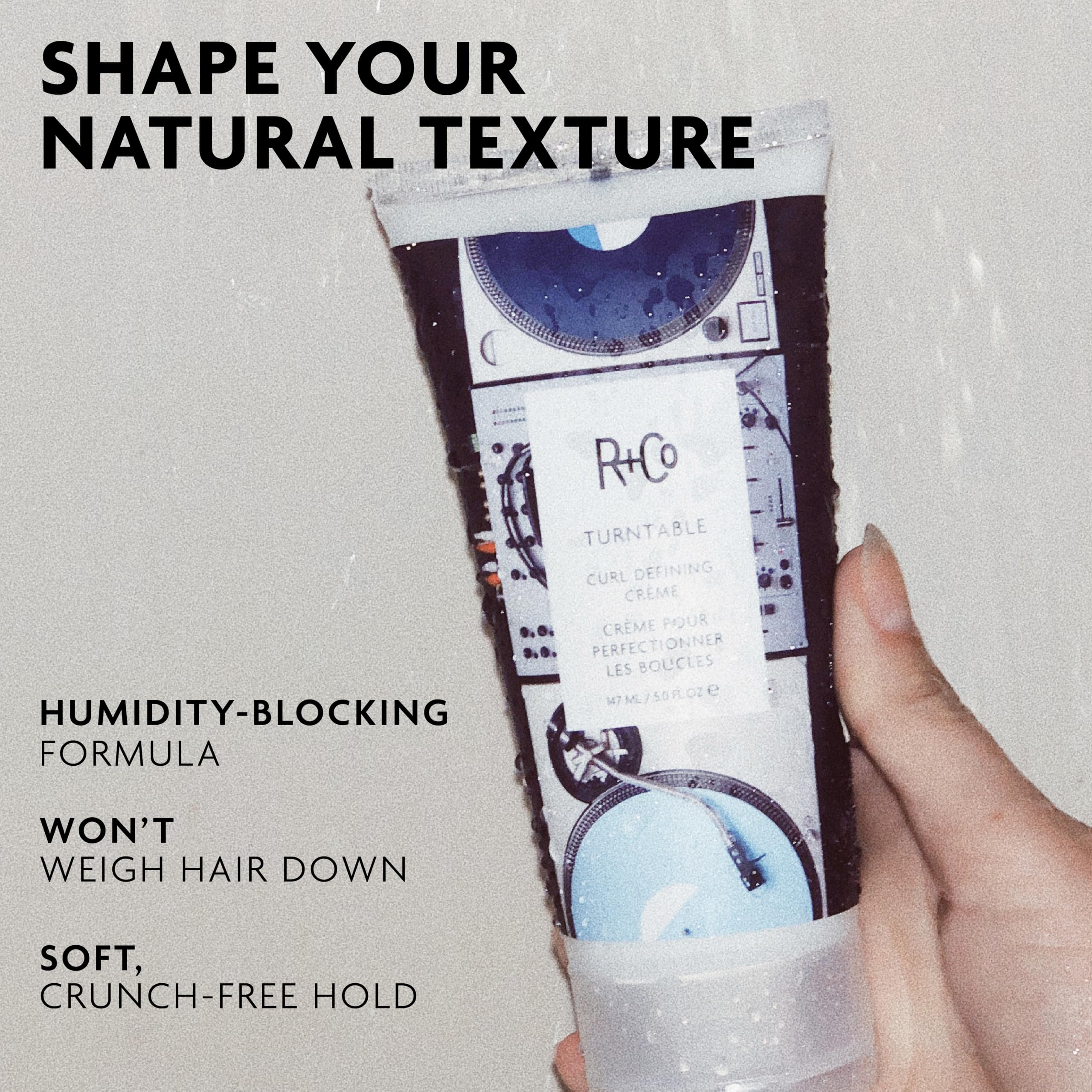 R+Co Turntable cream on hands ready to apply for smooth, defined curls