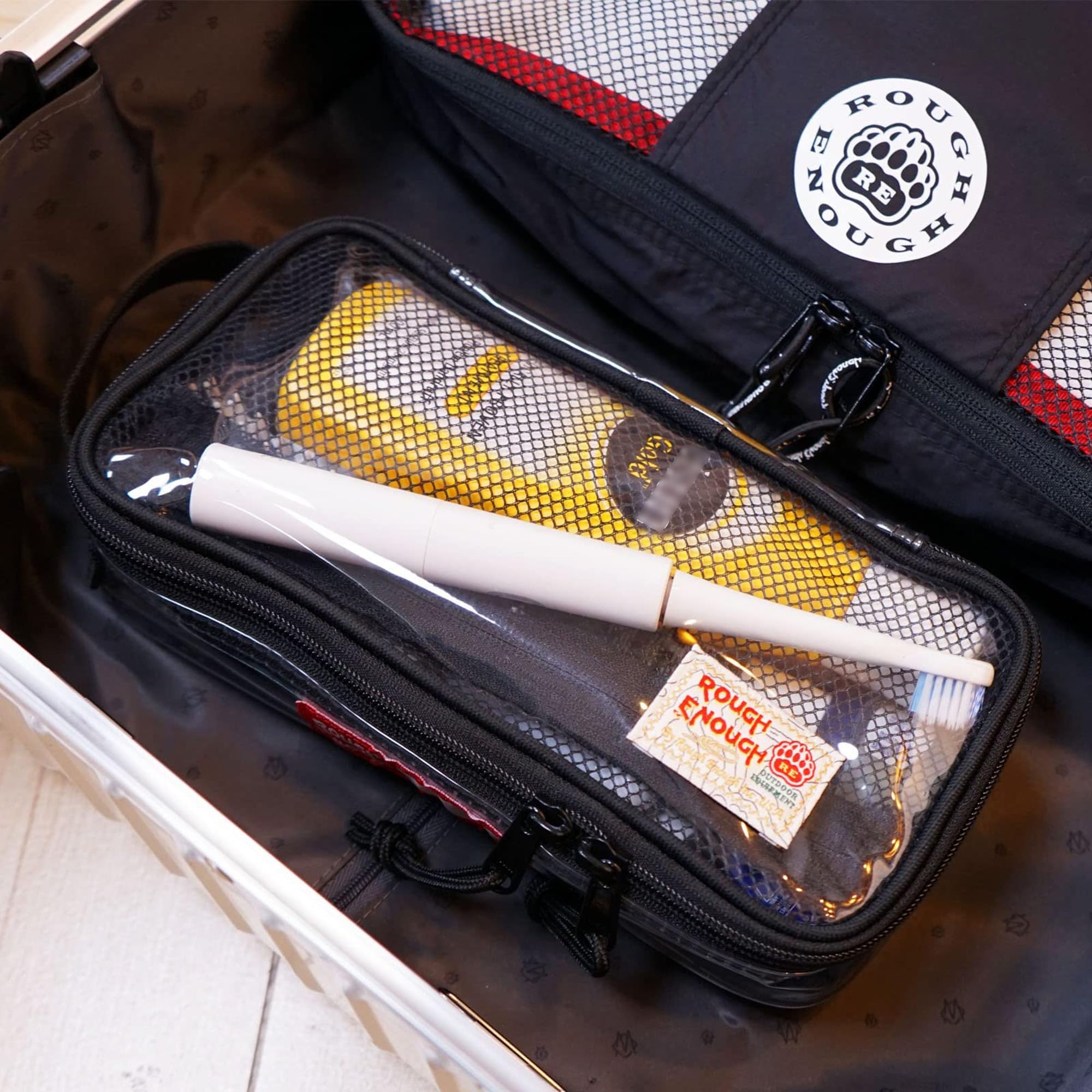 RE ROUGH ENOUGH filled pouch with shaving kit illustrating capacity
