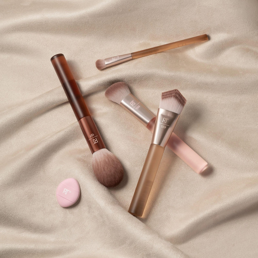 Real Techniques Mini Miracle Powder Puff shown in hand, sets under-eye makeup cleanly