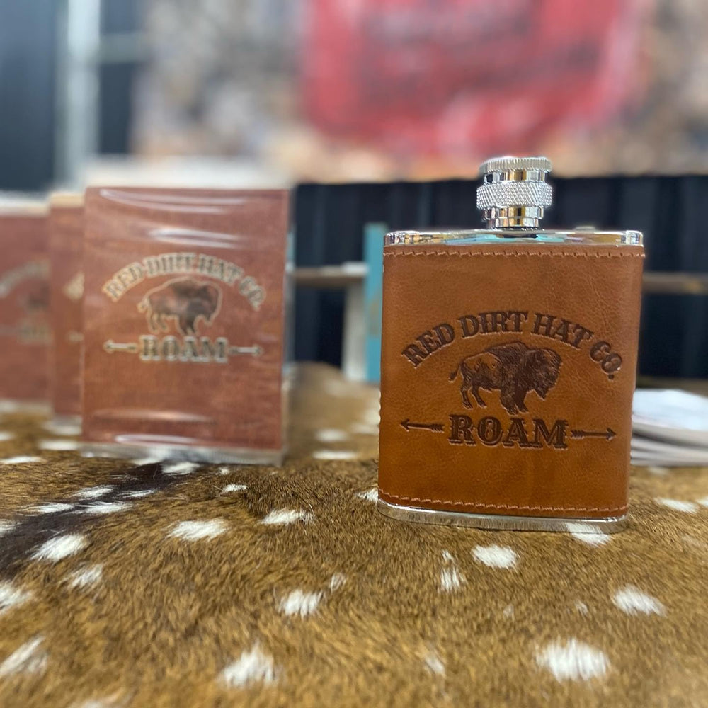 Red Dirt Hat Company bottle on dresser adding stylish grooming display