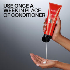 Redken Frizz Dismiss being applied to towel-dried hair for smoother results