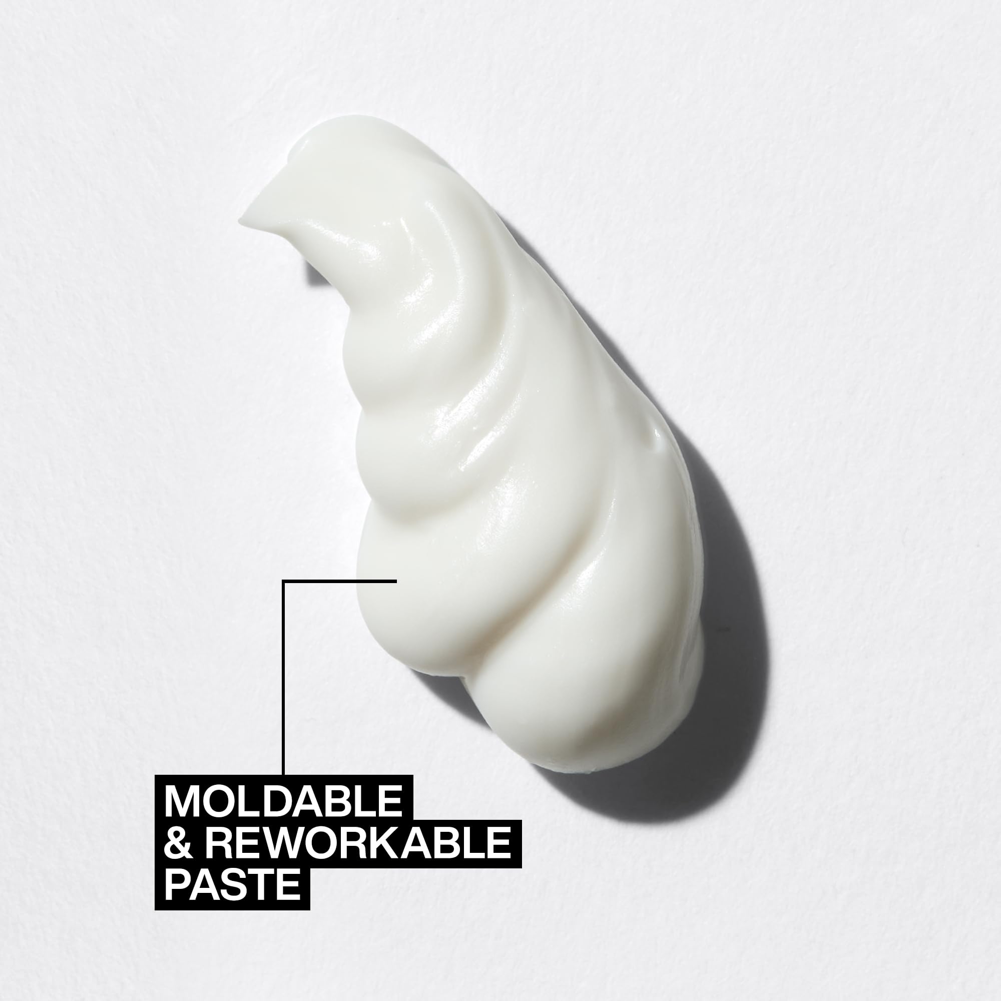 Redken paste being rubbed between hands demonstrating even application and control