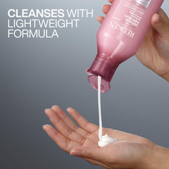 Redken shampoo on bathroom shelf styled for effortless volumizing routine