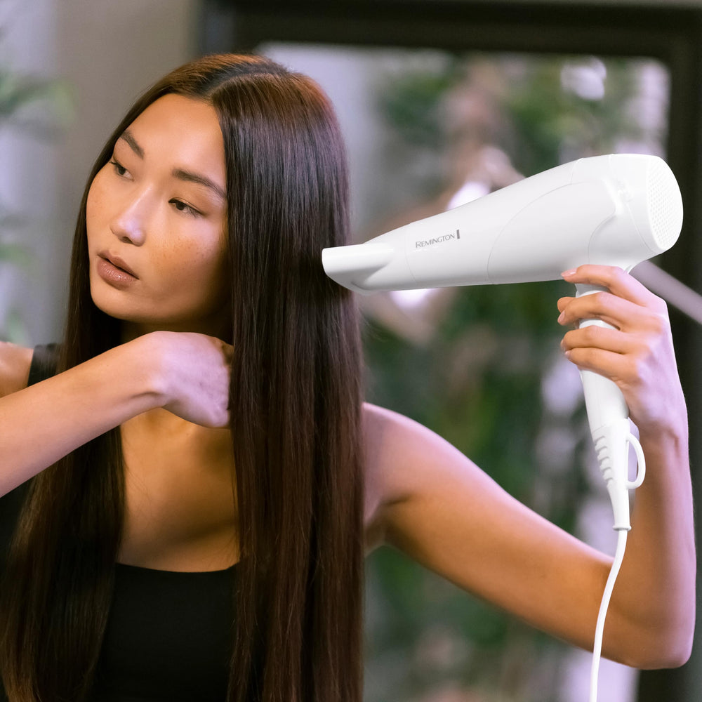 Remington dryer on bathroom counter next to mirror for everyday convenient storage