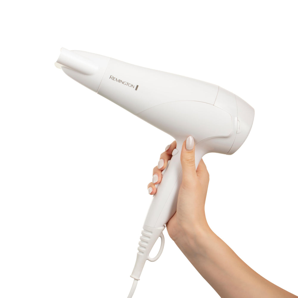 Remington hair dryer held in hand to show size and comfortable ergonomic benefit