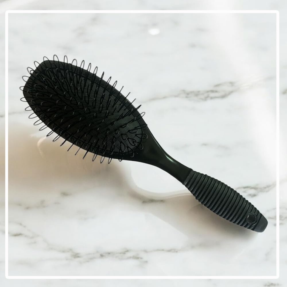 RemySoft detangling bonded extensions gently with loop bristles to preserve attachments