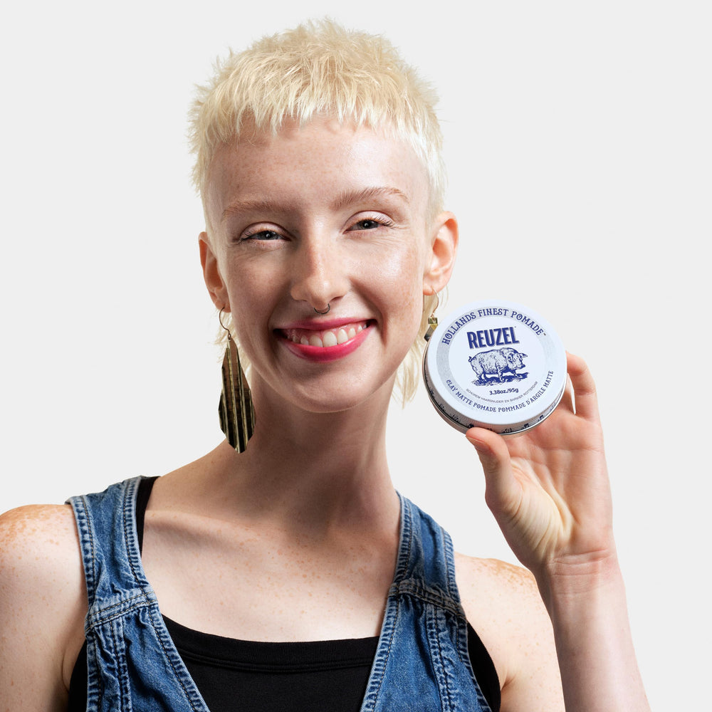 REUZEL pomade in travel bag lifestyle scene illustrating ready-to-go freshness