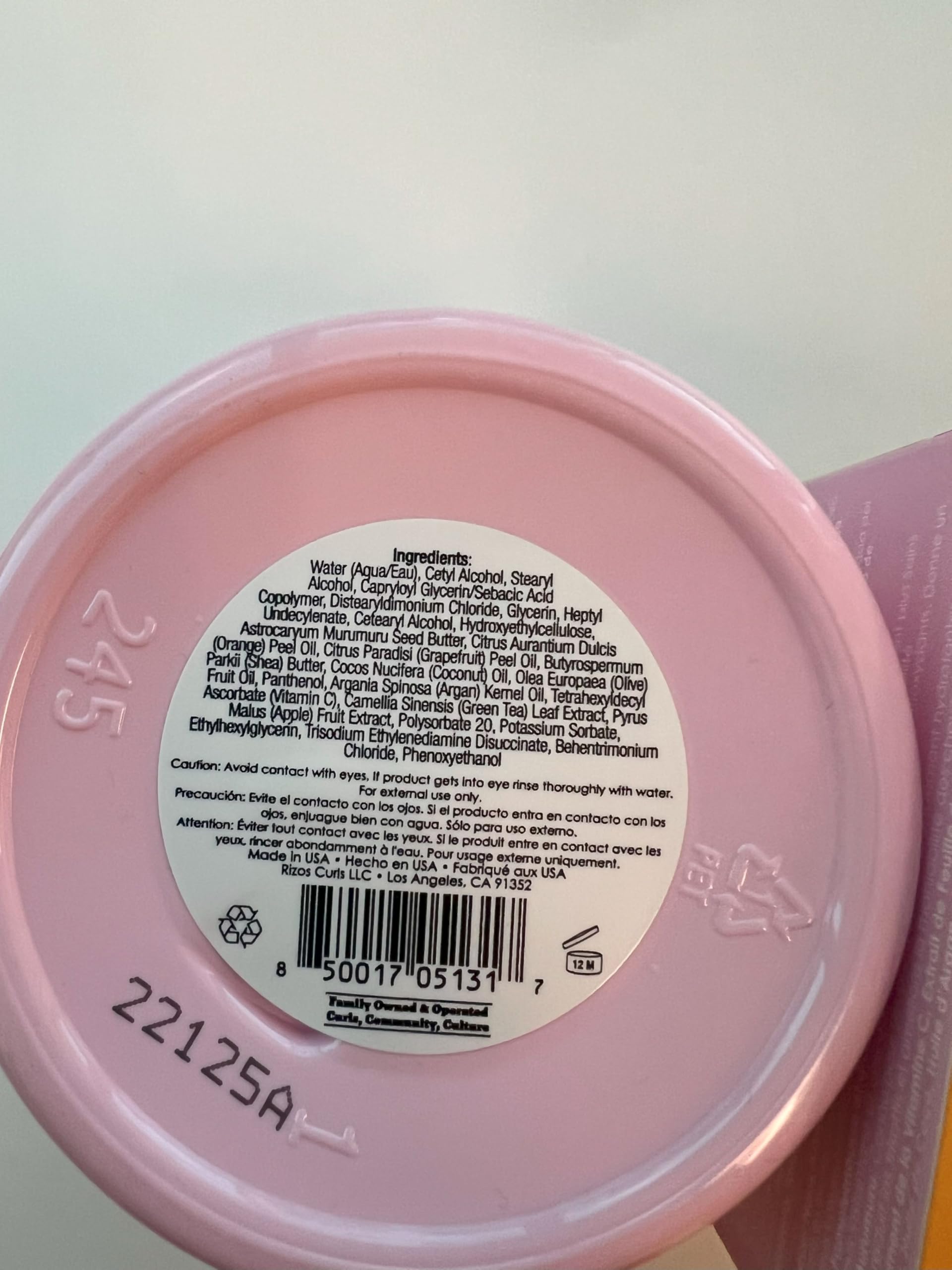 Rizos Curls 10 oz jar in hand to indicate size and portability benefit