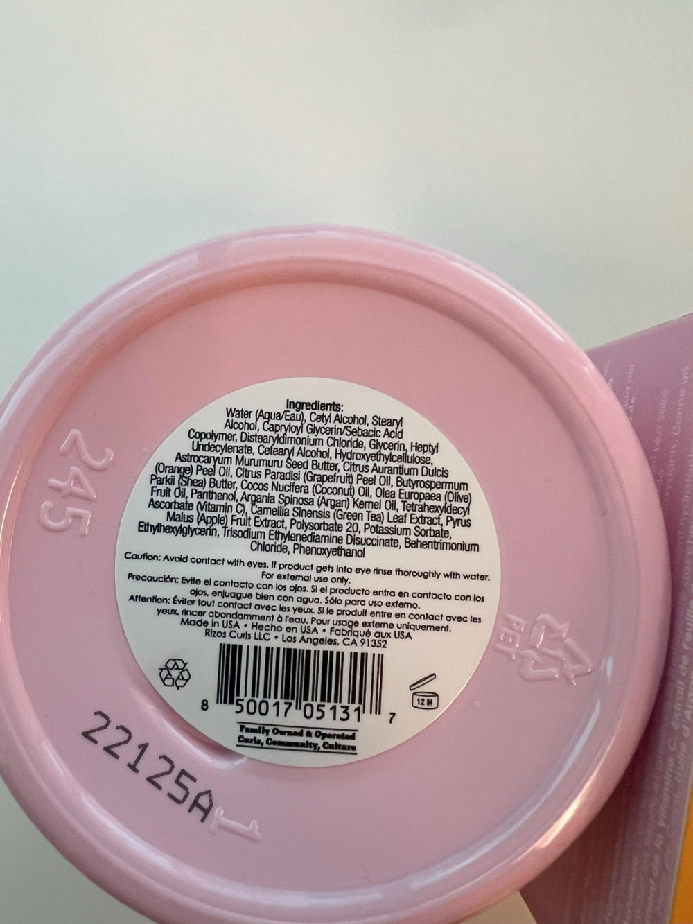 Rizos Curls 10 oz jar in hand to indicate size and portability benefit