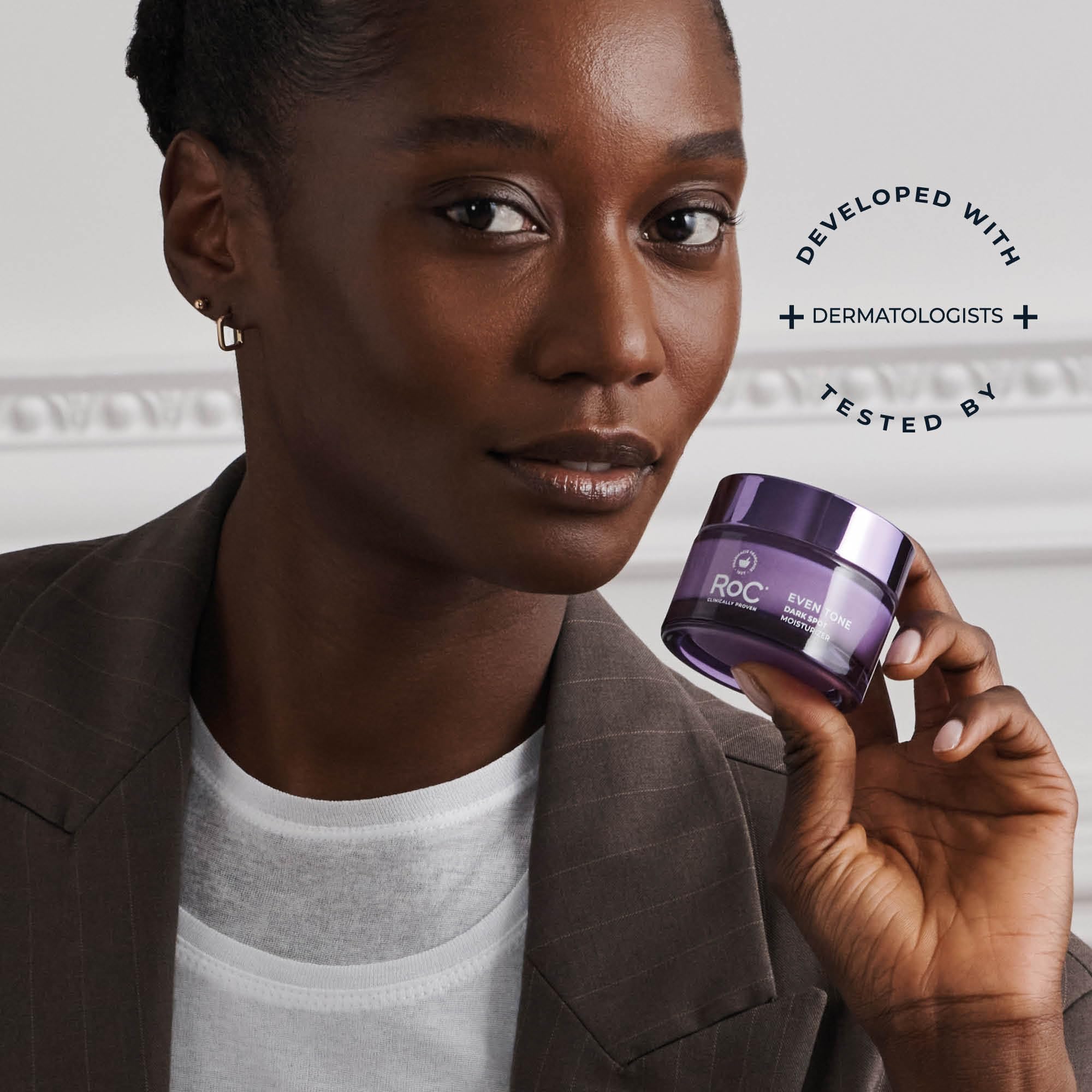 RoC night cream on bathroom shelf with plants, conveys skincare ritual and calming luxury