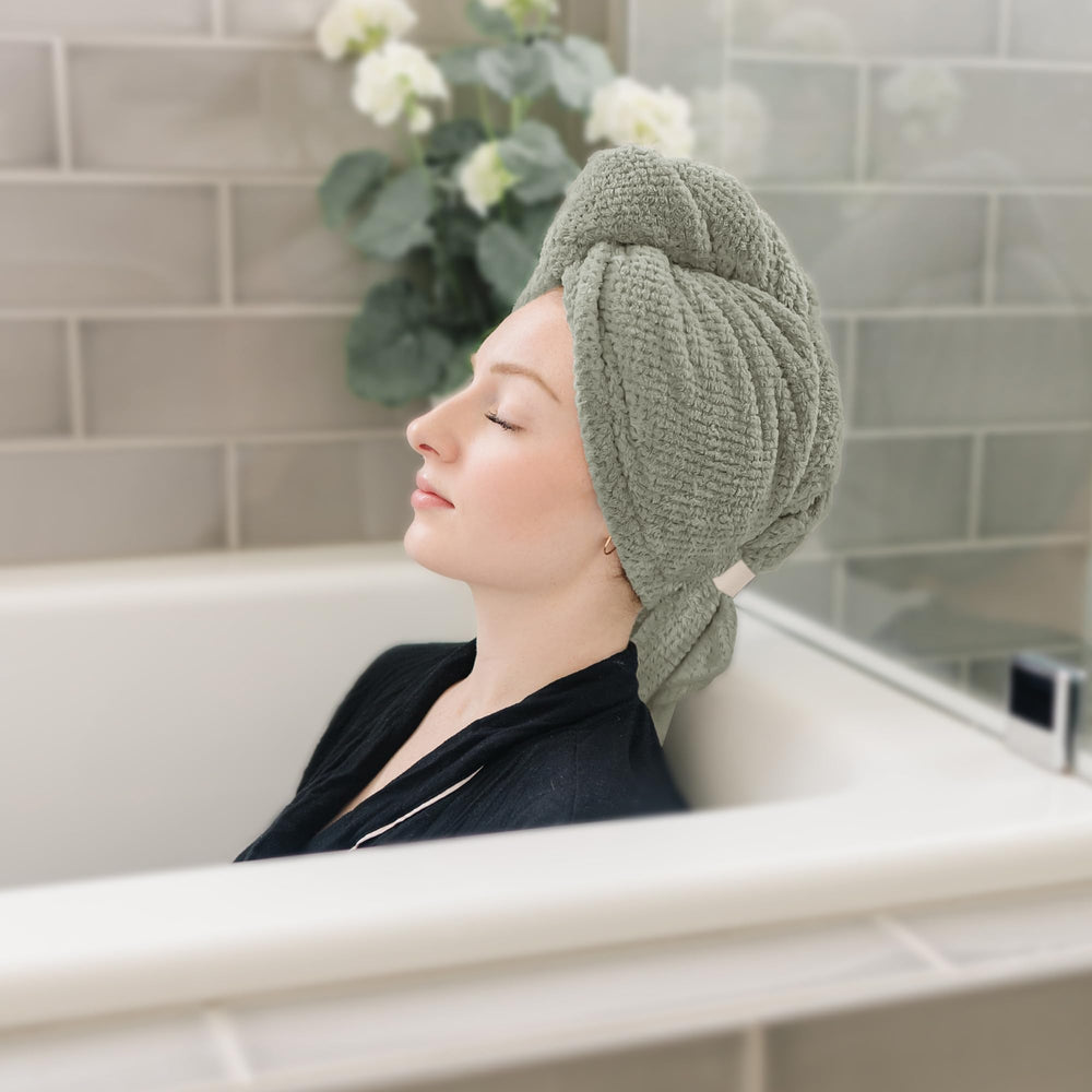 ROLSHOL towel beside hand to show 27x39 inch scale for full hair coverage benefit