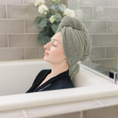 ROLSHOL towel beside hand to show 27x39 inch scale for full hair coverage benefit