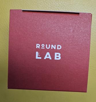round lab cream on fingertip demonstrating spreadability and absorption benefit