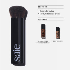 Saie brush in use pressing foundation into cheek for natural skin finish