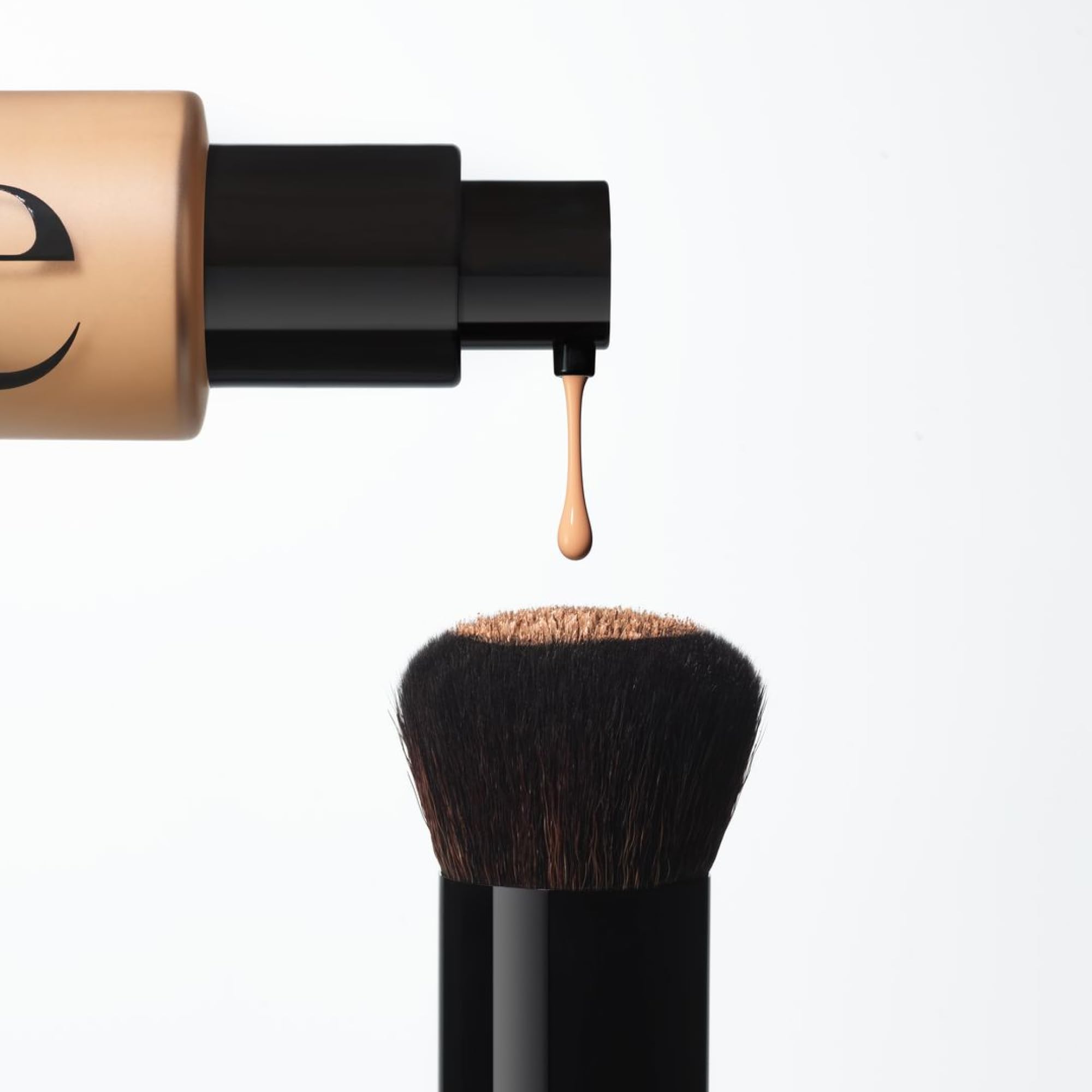 Saie brush held in hand to show size and ease of handling for precise application