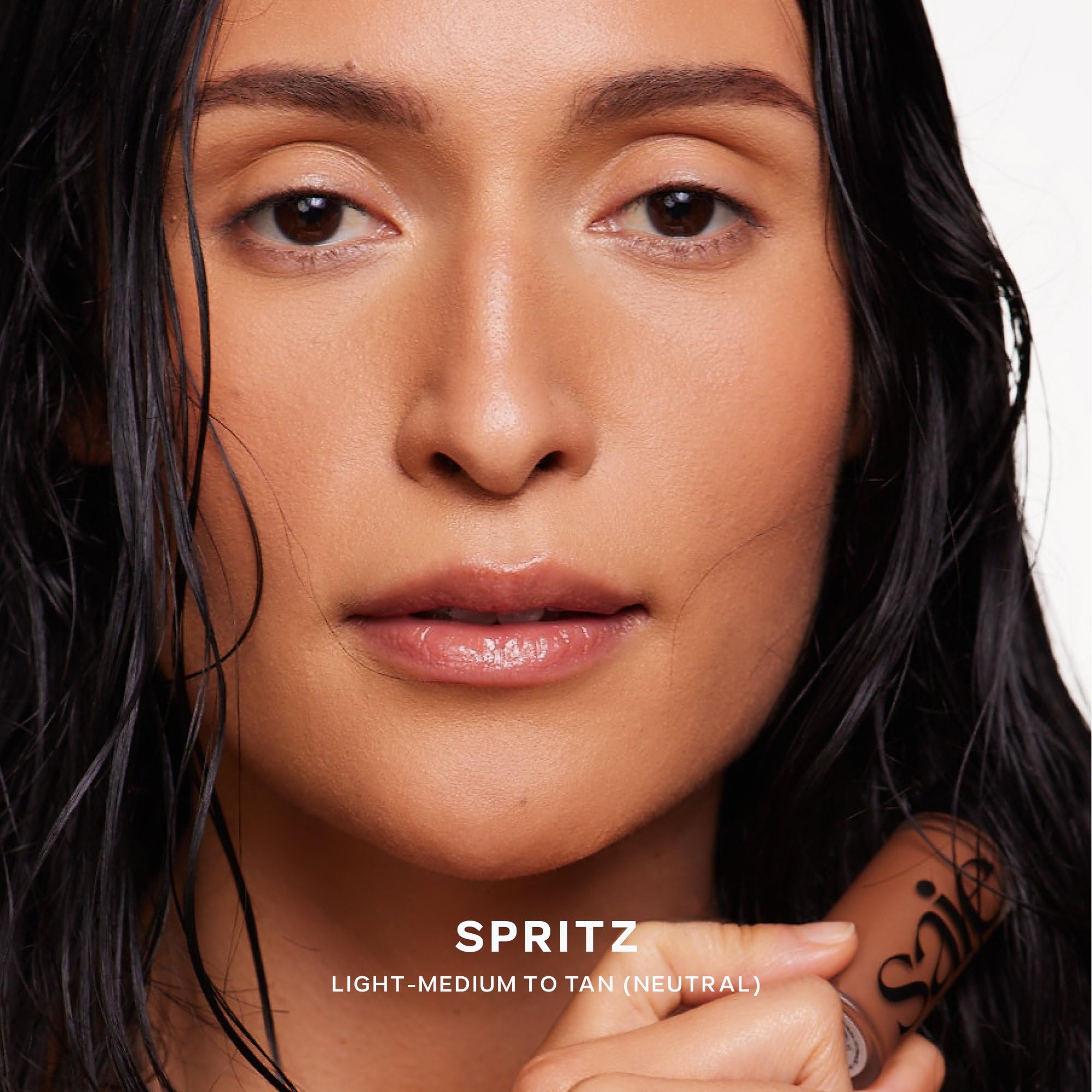 Saie Dew Bronze applied to cheek demonstrating instant sun-kissed glow and hydration