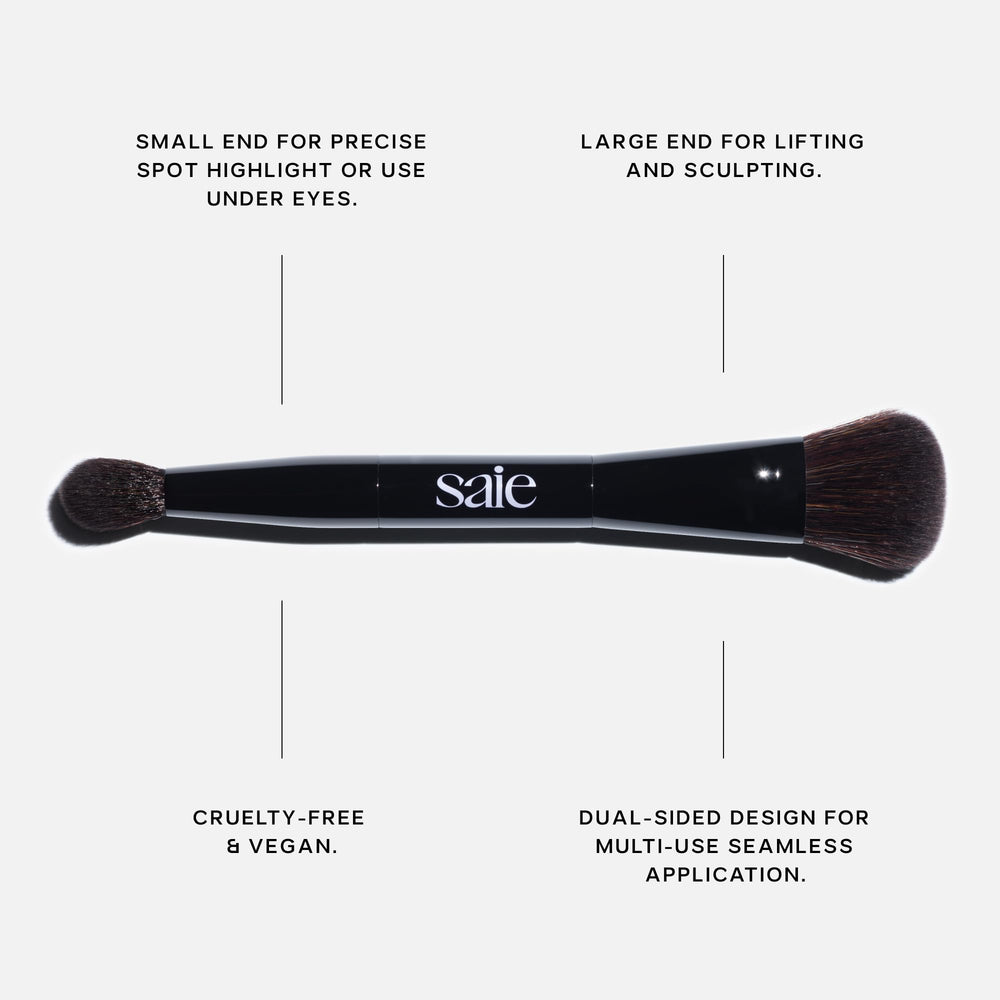 Saie brush in use applying cream highlighter to cheekbone for seamless glow