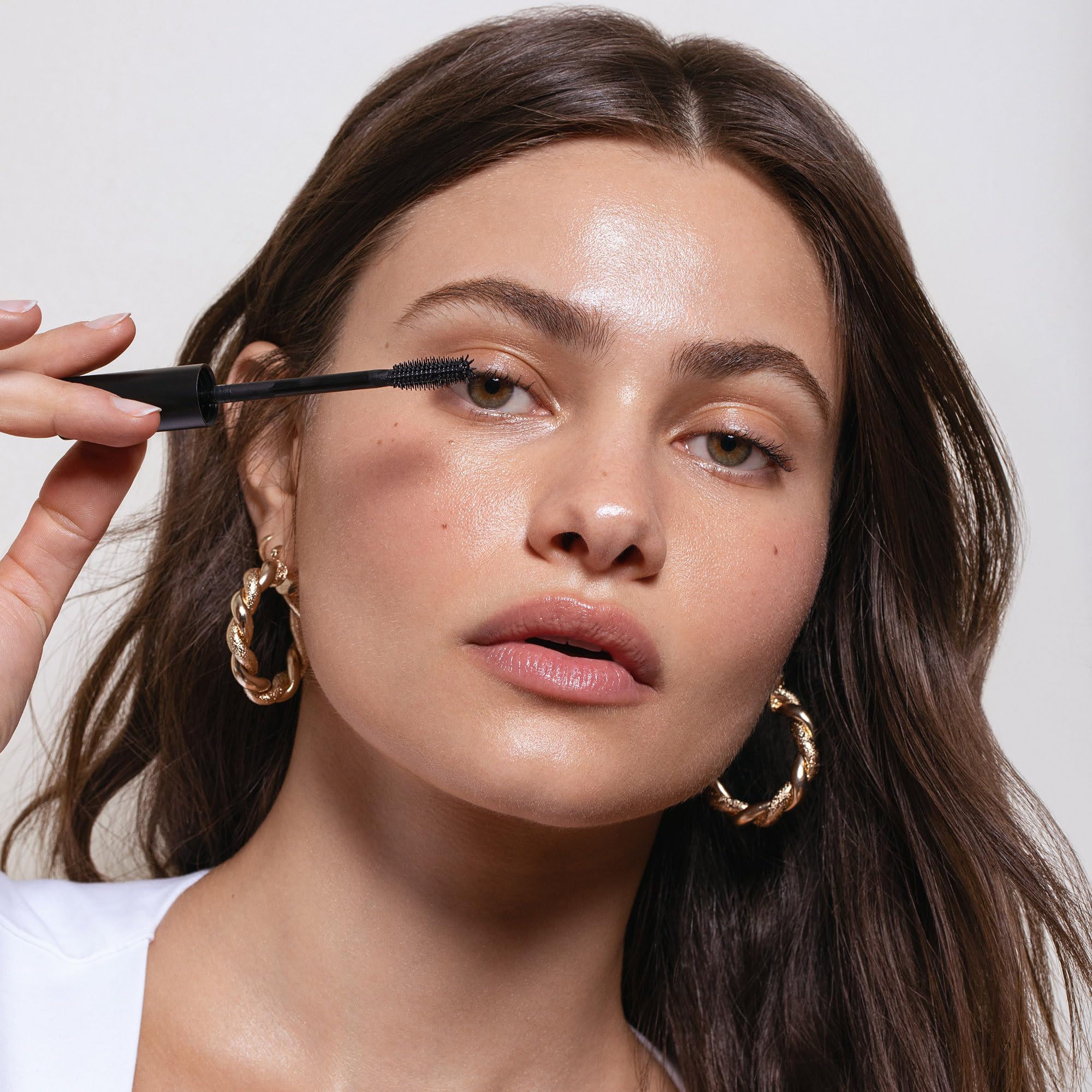 Saie tube held in hand to show true size and portability for on-the-go touch ups