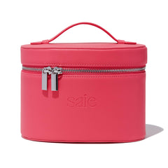 Saie Mini Vanity Case front view showing fuchsia vegan leather and secure zip, adds polish